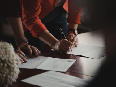 People writing on documents