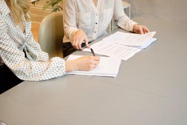 Two people with documents